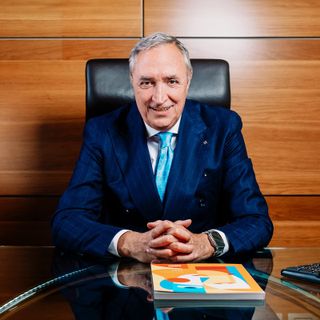 Uomo in primo piano seduto alla scrivania