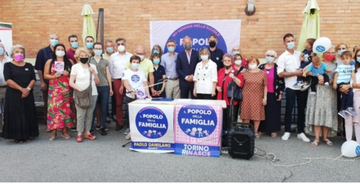 politici in piedi dietro a bandiere di partito