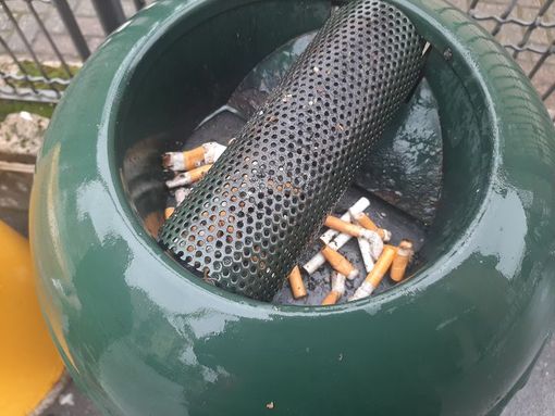 Svuota il posacenere a terra ma viene rimproverato e costretto a prendere scopa e paletta per pulire