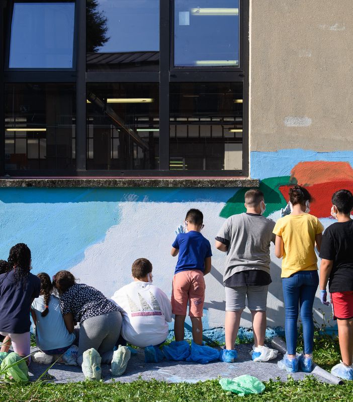 persone che dipingono un murales