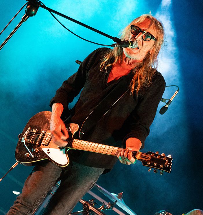 Giorgio Canali suona la chitarra sul palco e canta