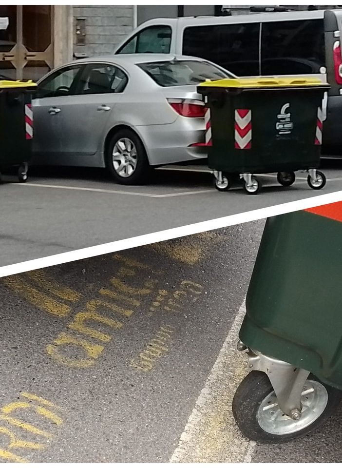 auto circondata da bidoni dell'immondizia