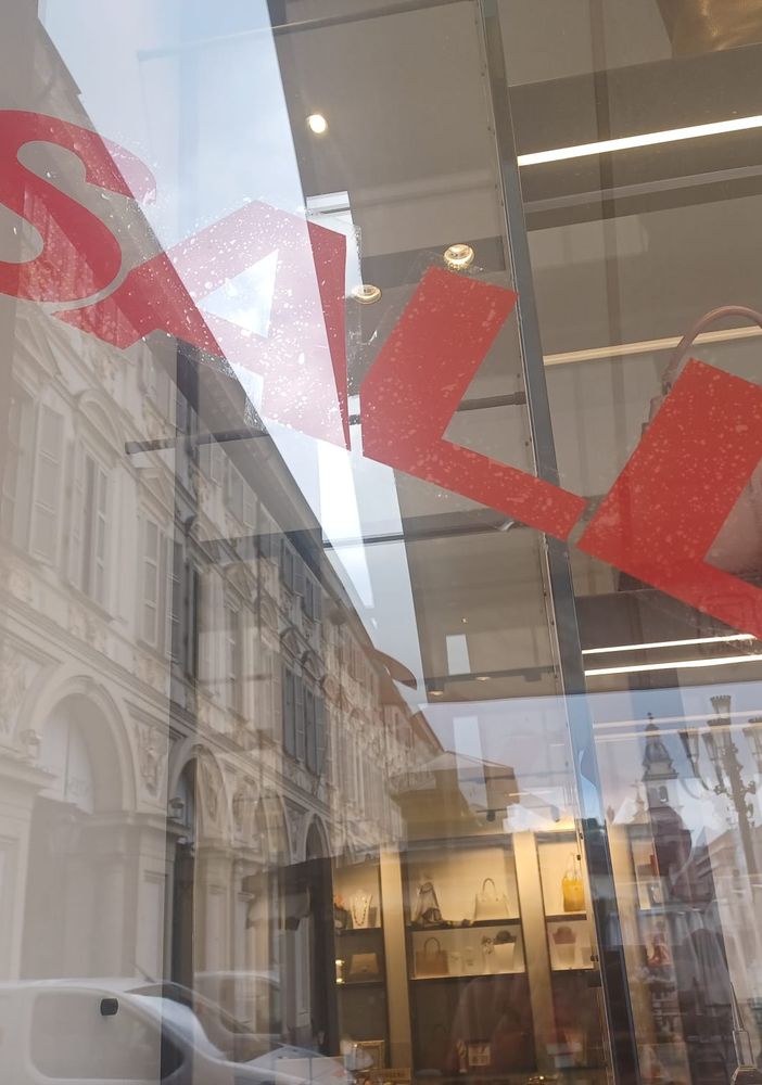 Vetrina con la scritta &quot;Saldi&quot; in diagonale e in rosso