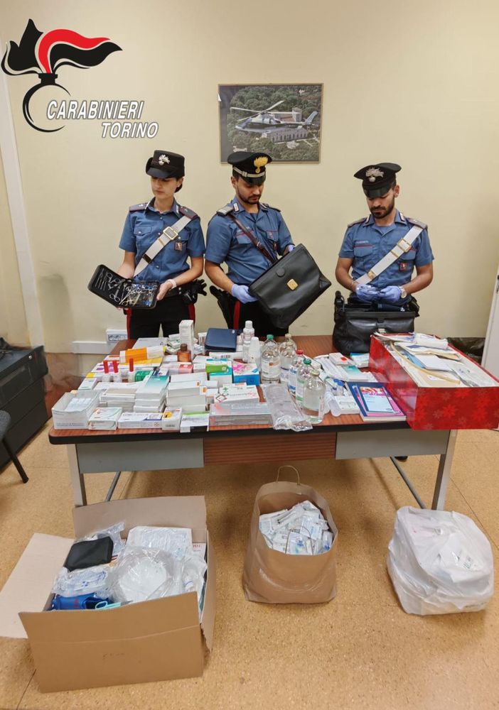 carabinieri con tavolo di oggetti sequestrati