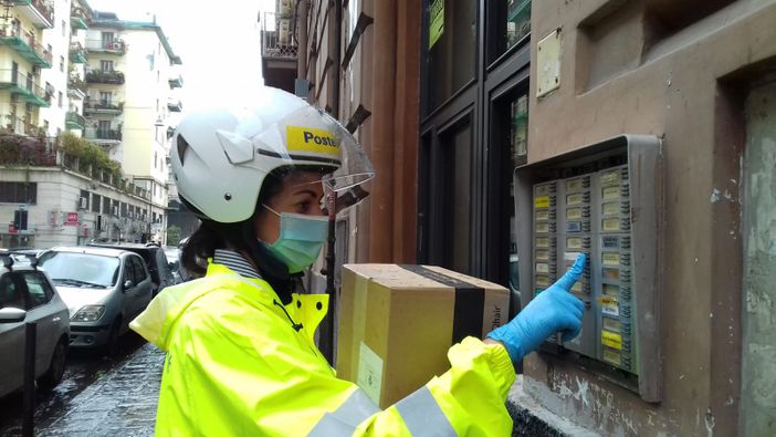 Postino che citofona per consegnare un pacco