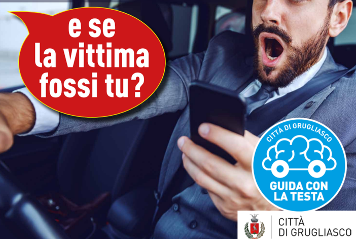 uomo che guida con il cellulare in mano