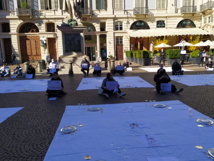 Torino, flash mob degli esercenti in Piazza Carignano: “Siamo a terra ma ci rialzeremo” [VIDEO]