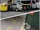auto circondata da bidoni dell'immondizia