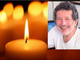 candela accesa e viso primo piano