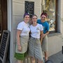 Commercianti cavouresi sotto una lavagnetta con frase motivante