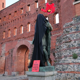 Extinction Rebellion ha coperto con un telo nero le statue di Cesare e Augusto