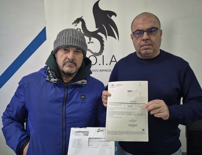 Giancarlo Nardozzi con il negoziante di Barriera e i bollettini da pagare