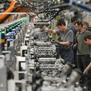 Linea di produzione di manifattura con operai in piedi