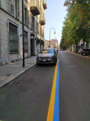 Strisce blu e gialle in centro a Torino con auto parcheggiate