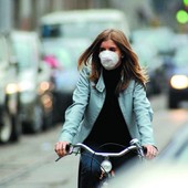 persona in bici con mascherina per smog